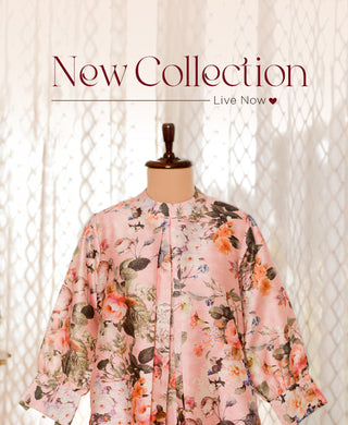 A floral-patterned pink jacket displayed on a mannequin with the text "New Collection Live Now" in elegant font above.