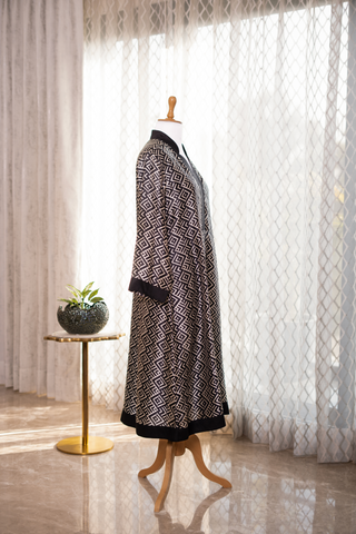 Side view of elegant black and white patterned co-ord set displayed on a mannequin, set against sheer curtains with soft natural lighting.