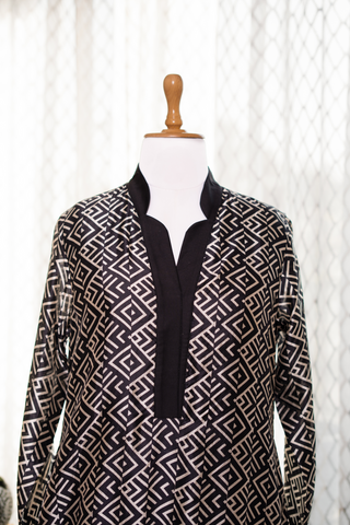 Black and white geometric printed kurta displayed on a mannequin, styled with a mandarin collar and three-quarter sleeves.