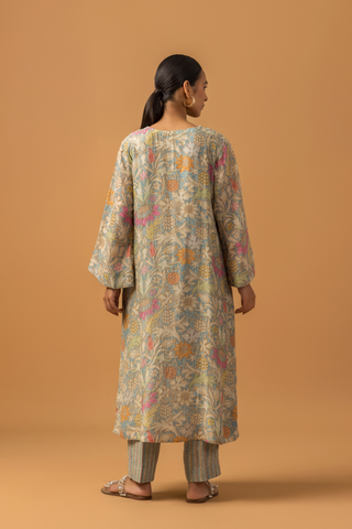 Back view of a model wearing a floral-patterned linen co-ord set and matching palazzo pants, set against a warm, neutral background.