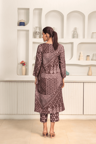 Back view of woman is wearing a Brown printed linen cord set with intricate white patterns, paired with matching printed pants
