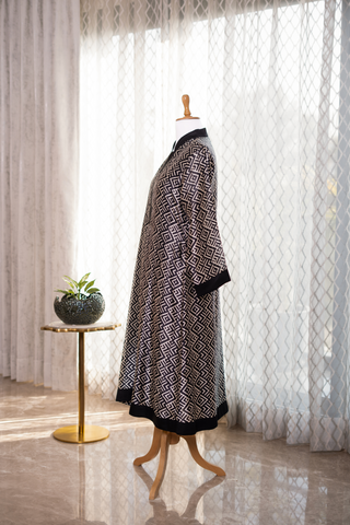 Side view of black and white patterned co-ord set displayed on a mannequin, set against sheer curtains with soft natural lighting.
