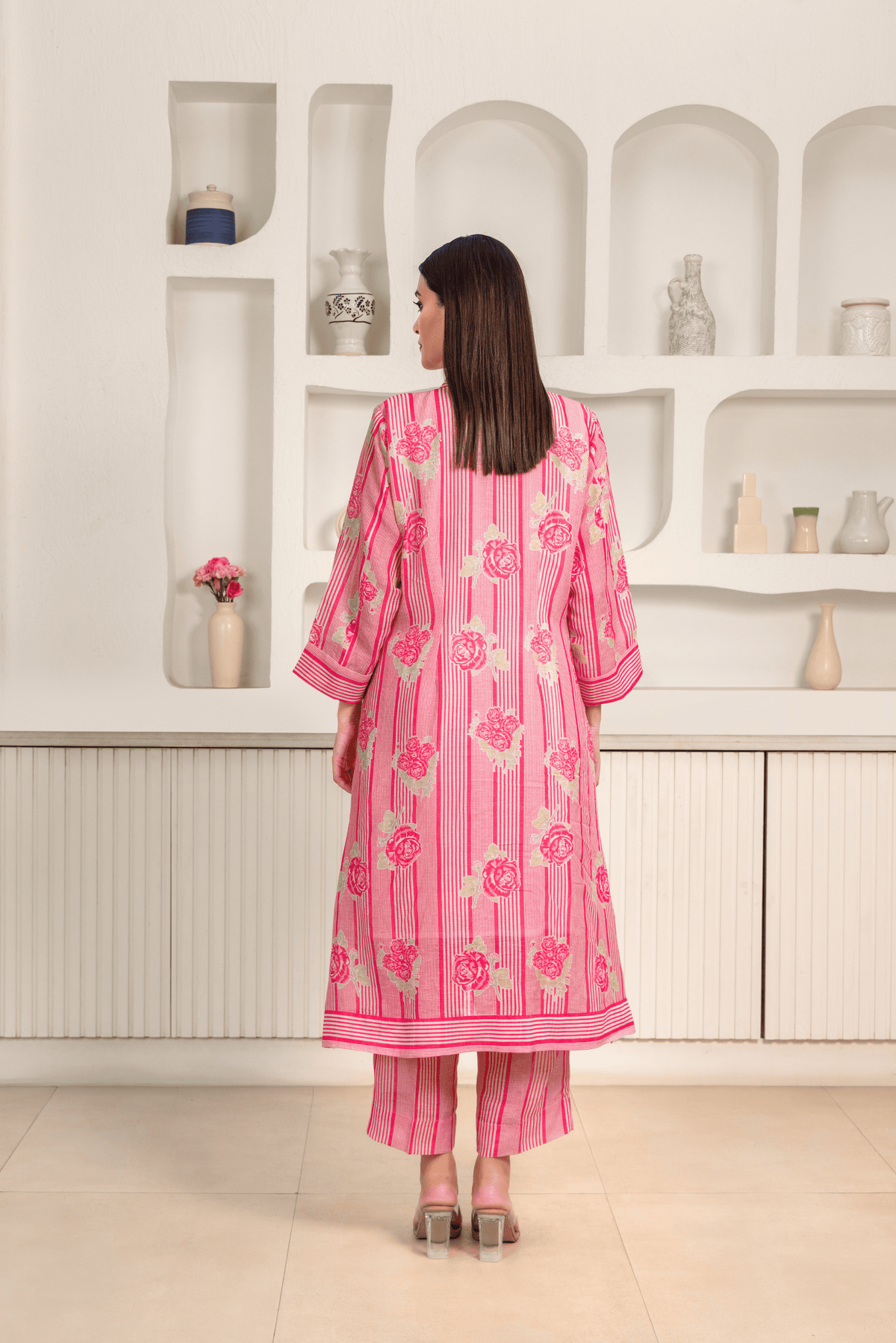 Back view of women wearing pink floral printed kurta set with a contemporary design