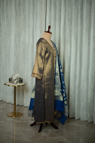 Side view of a dark grey ethnic outfit featuring intricate gold embroidery down the front and a matching blue dupatta draped on the side.