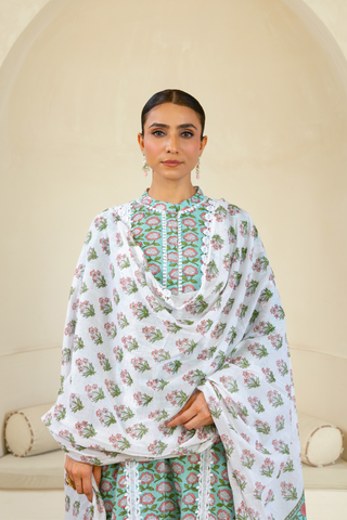 Closeup View of Model wearing a green handcrafted kurta with floral patterns, paired with white lace pants, showcasing a blend of traditional and contemporary ethnic wear.