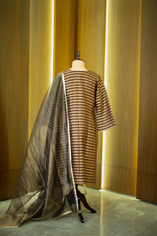 back view of black and gold striped kurta paired with a sheer, shimmering dupatta, displayed on a mannequin against a warm wooden backdrop.