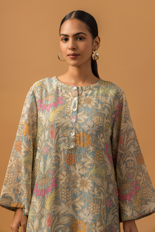 Back view of a model wearing a floral-patterned linen co-ord set and matching palazzo pants, set against a warm, neutral background.