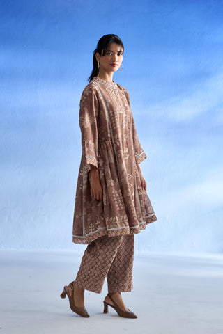 Woman wearing a patterned linen co-ord set against a blue sky