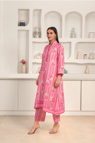 A women wearing pink floral printed kurta set with a contemporary design