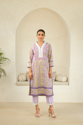 Model wearing a lavender handcrafted kurta with intricate patterns, white detailing, and paired with striped lavender pants, reflecting timeless ethnic elegance