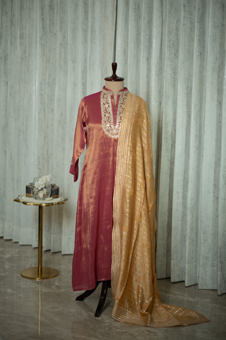 Rich maroon silk kurta with intricate embroidery and golden dupatta, exuding timeless elegance and luxury, displayed in a sophisticated setting.