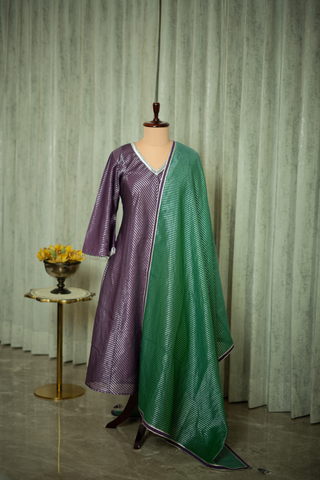 purple tissue chanderi kurta with a shimmering striped pattern, paired with a rich green tissue chanderi dupatta, featuring delicate silver detailing.