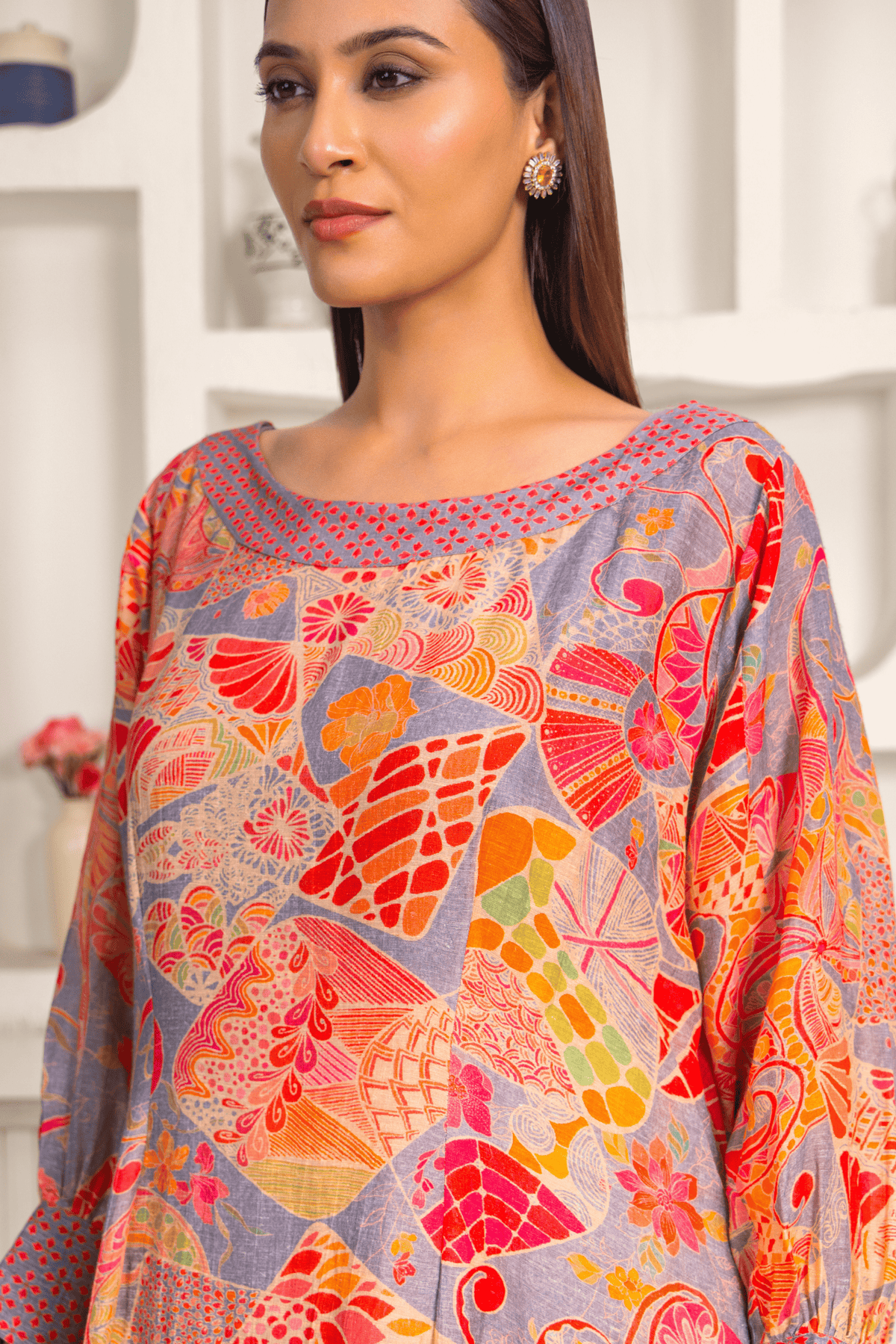 Close up View of woman is wearing a vibrant floral printed mosaic linen cord set paired with matching printed pants.